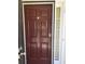 Close-up of the dark brown front door with glass sidelight and modern hardware at 10221 Deep Creek Pl, Union City, GA 30291