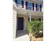 Inviting front entrance with a black door, security camera, and well-trimmed shrubbery at 10221 Deep Creek Pl, Union City, GA 30291