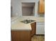A functional kitchen featuring an undermounted stainless steel sink and wood cabinets at 10221 Deep Creek Pl, Union City, GA 30291