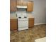 A functional kitchen featuring wood cabinets, laminate countertops, and neutral flooring at 10221 Deep Creek Pl, Union City, GA 30291