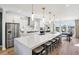 Spacious open-concept kitchen with a large island, stainless steel appliances, and modern pendant lighting at 1115 Rivard Nw Cir, Atlanta, GA 30318