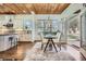 Open dining area with hardwood floors, modern lighting, and access to kitchen and outdoor patio at 2987 Jefferson St, Atlanta, GA 30341