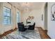 Stylish dining room with a round table, black chairs, decorative light fixture and hardwood floors at 2987 Jefferson St, Atlanta, GA 30341