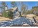 Exterior of home with large driveway and attached two-car garage, fenced yard at 2987 Jefferson St, Atlanta, GA 30341