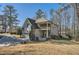 View of the home's back exterior featuring a covered patio, balcony, and attached two-car garage at 2987 Jefferson St, Atlanta, GA 30341
