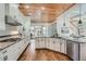 Well-lit kitchen with stainless steel appliances, granite counters, white cabinets, and access to the dining area at 2987 Jefferson St, Atlanta, GA 30341