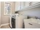 Well-equipped laundry room with sink, washer, and dryer, plus storage cabinets at 2987 Jefferson St, Atlanta, GA 30341