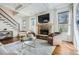 Cozy living room featuring hardwood floors, a brick fireplace with a TV, and large windows with natural light at 2987 Jefferson St, Atlanta, GA 30341