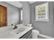 A powder room featuring a modern sink, new mirror, tile flooring, and natural light at 3430 Pate Rd, Snellville, GA 30078