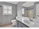 Neutral bathroom featuring a modern vanity, toilet and shower/tub combo at 3430 Pate Rd, Snellville, GA 30078