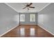 Large bedroom with hardwood floors, ceiling fan and two windows with natural light at 3430 Pate Rd, Snellville, GA 30078