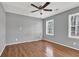 Bedroom featuring hardwood floors, ceiling fan and natural light with two windows at 3430 Pate Rd, Snellville, GA 30078