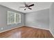 Spacious bedroom with hardwood floors, ceiling fan, and large window for natural light at 3430 Pate Rd, Snellville, GA 30078