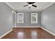 Bedroom featuring hardwood floors, grey walls, two windows, and ceiling fan at 3430 Pate Rd, Snellville, GA 30078