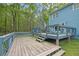 View of the wooden deck with tiered steps and blue railing near the home at 3430 Pate Rd, Snellville, GA 30078