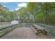 View of the wooden deck with picnic table and railing facing the large two car garage at 3430 Pate Rd, Snellville, GA 30078