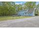 Exterior view of the house with a spacious yard, fenced perimeter, and garage at 3430 Pate Rd, Snellville, GA 30078