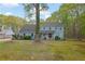 Charming two-story home features a light-blue exterior, landscaped yard, and mature trees at 3430 Pate Rd, Snellville, GA 30078