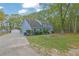 The home features a long drive leading to a multi-car garage with a spacious, treed yard at 3430 Pate Rd, Snellville, GA 30078