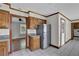 Well-lit kitchen with stainless steel appliances, wood cabinets, and breakfast bar at 3430 Pate Rd, Snellville, GA 30078