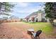 Spacious backyard featuring mature trees, lush lawn, patio area, and a cozy fire pit, perfect for outdoor gatherings at 5952 Edenfield Nw Dr, Acworth, GA 30101