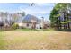 This large backyard is surrounded by mature trees and a wooden fence, offering privacy and a peaceful setting at 5952 Edenfield Nw Dr, Acworth, GA 30101
