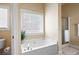 Bright bathroom with soaking tub, window and a separate shower at 5952 Edenfield Nw Dr, Acworth, GA 30101