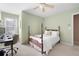 This bedroom features a bed with white linens, a wooden frame, and a work area with a desk and chair at 5952 Edenfield Nw Dr, Acworth, GA 30101