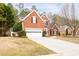 Traditional two-story brick home with attached garage, manicured landscaping, and a welcoming driveway at 5952 Edenfield Nw Dr, Acworth, GA 30101