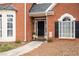 Close-up of the red brick facade and covered front entryway of a two-story home at 5952 Edenfield Nw Dr, Acworth, GA 30101