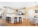Open-concept kitchen with bar seating, white cabinets, stainless appliances, and breakfast nook at 5952 Edenfield Nw Dr, Acworth, GA 30101