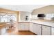 Bright kitchen with white cabinets, wood floors, and a breakfast area at 5952 Edenfield Nw Dr, Acworth, GA 30101