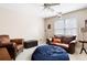 Cozy living room with comfortable leather seating and ceiling fan at 5952 Edenfield Nw Dr, Acworth, GA 30101