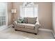 Cozy sitting area with loveseat, large window and neutral color palette at 5952 Edenfield Nw Dr, Acworth, GA 30101