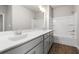 Bright bathroom featuring a long vanity, large mirror and tub at 7 Hydrangea Unit 70 Way, Auburn, GA 30011