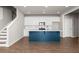 Modern kitchen with island, white cabinets, stainless steel appliances, and hardwood floors at 7 Hydrangea Unit 70 Way, Auburn, GA 30011