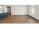 Open-concept living area with hardwood floors, modern lighting, and kitchen island at 7 Hydrangea Unit 70 Way, Auburn, GA 30011