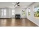 Bright living room featuring hardwood floors, fireplace, and ceiling fan at 7 Hydrangea Unit 70 Way, Auburn, GA 30011