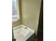 Bathroom featuring a white tub, shower and window enhancing natural light in this lovely bathroom at 10 Chapman Way, Covington, GA 30016