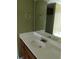 Bathroom featuring double vanity with a large mirror and faucet, complementing green walls at 10 Chapman Way, Covington, GA 30016