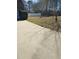 Driveway leading to the garage with a view of the spacious front yard and partial white fence at 10 Chapman Way, Covington, GA 30016