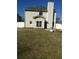 Back exterior of home with neutral siding, windows, and a view of the backyard and fire pit at 10 Chapman Way, Covington, GA 30016