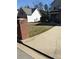 View of front yard shows the lawn, driveway, brick mailbox, and house, but the grass is dry and not appealing at 10 Chapman Way, Covington, GA 30016