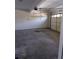 Spacious two-car garage with concrete floors and overhead lighting at 10 Chapman Way, Covington, GA 30016