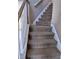 Carpeted staircase with white wood railing at 10 Chapman Way, Covington, GA 30016