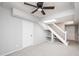 Finished basement space with carpet, ceiling fan, stairs, storage and white trim at 2647 Wood Hollow Dr, Dunwoody, GA 30360