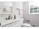 This bathroom features black plumbing fixtures, white cabinets and countertop, with a large framed mirror at 2647 Wood Hollow Dr, Dunwoody, GA 30360
