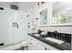 Updated bathroom with dual sinks, black granite countertops, and a glass enclosed shower with mosaic tile at 2647 Wood Hollow Dr, Dunwoody, GA 30360