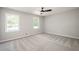 Spacious bedroom features a ceiling fan, neutral carpet, and two large windows for ample light at 2647 Wood Hollow Dr, Dunwoody, GA 30360