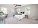 Bright bedroom with neutral colors, large windows, ceiling fan and plush carpeting at 2647 Wood Hollow Dr, Dunwoody, GA 30360